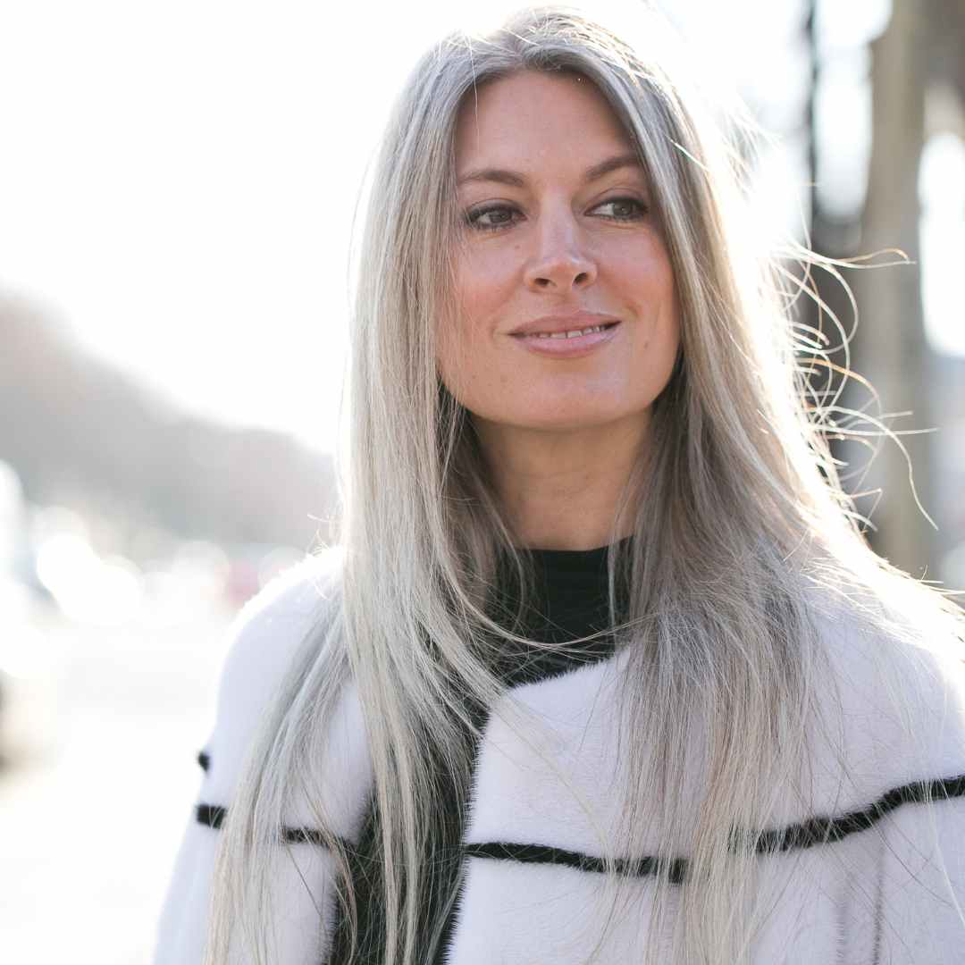 Long grey hairstyle female in white and black striped coat
