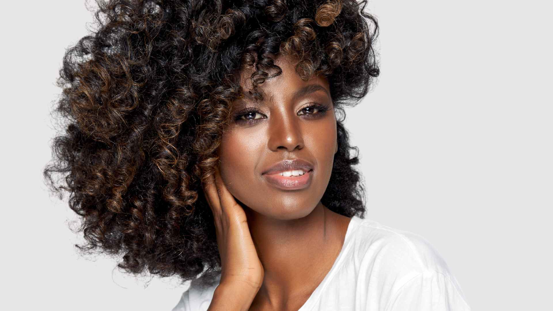 smiling female with afro coils in good condition after deep hair conditioner