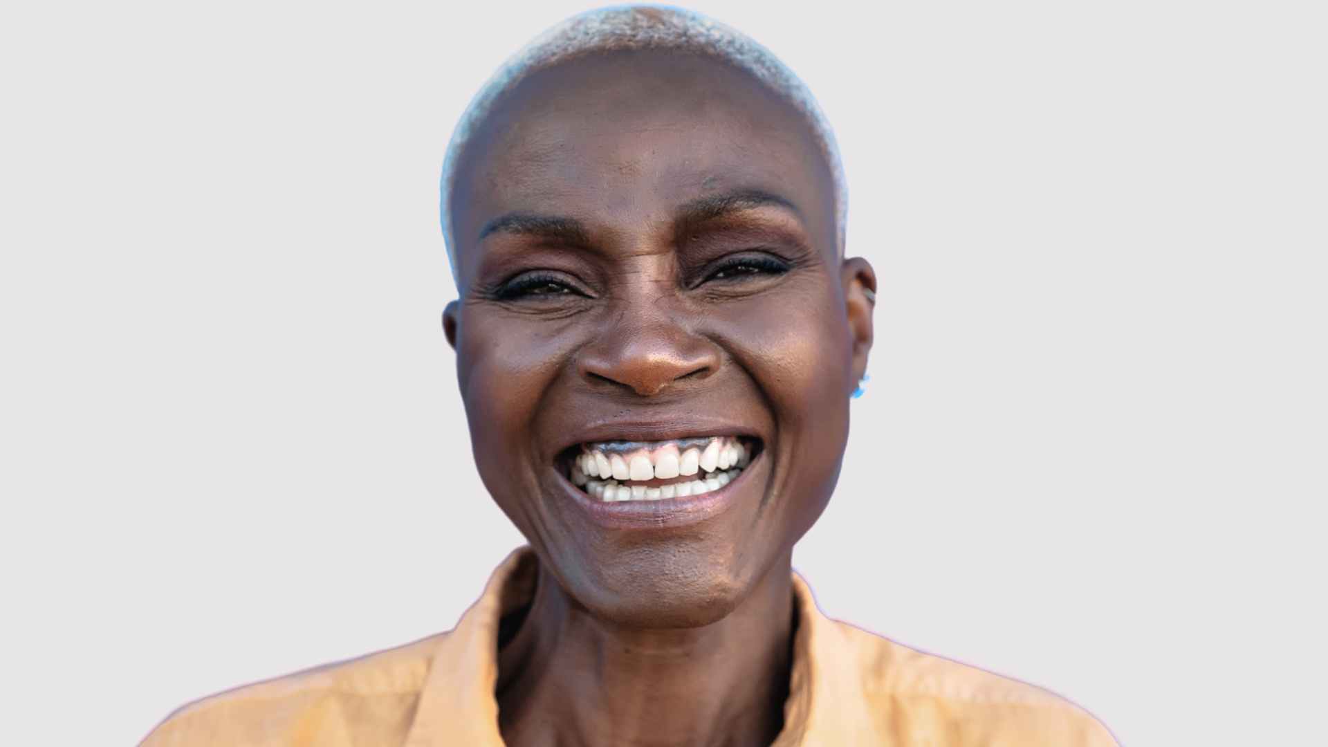 smiling woman with short shaved grey hair