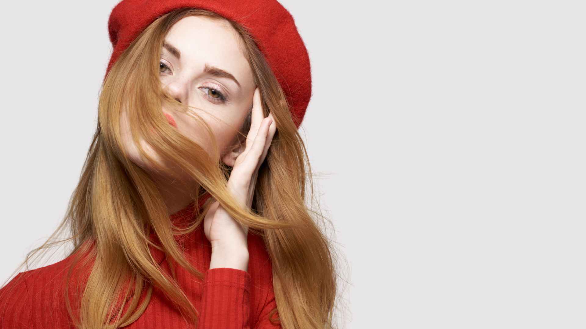 female with long red hair free of split ends, wearing red beret