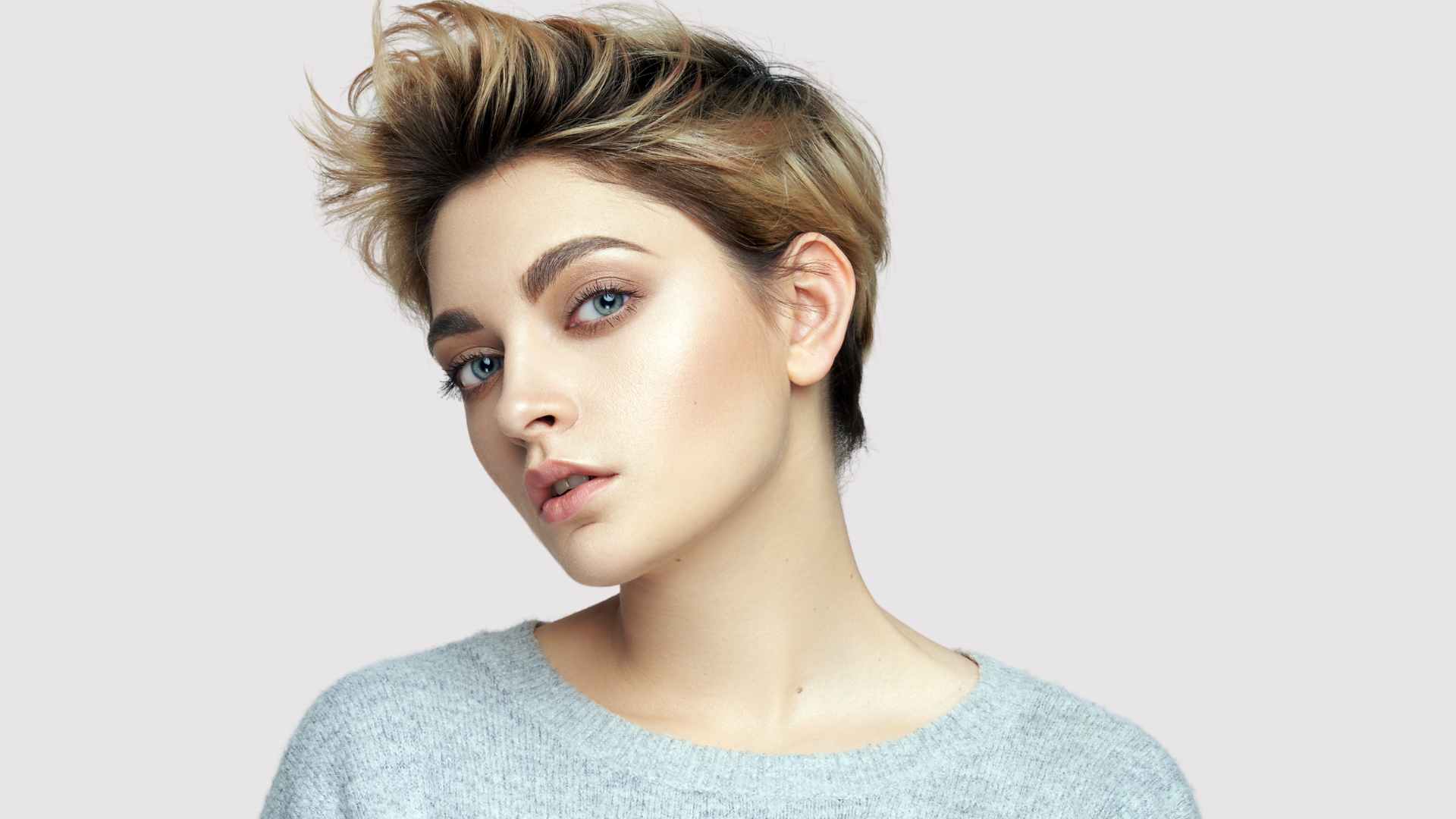 female with short fine hair with blonde highlights